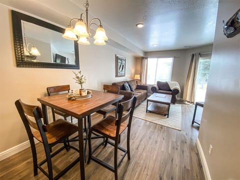 Charming dining and living area with warm lighting and cozy seating, perfect for relaxing evenings.