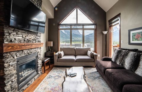 Relax and enjoy stunning mountain views in front of the fireplace in your home away from home.