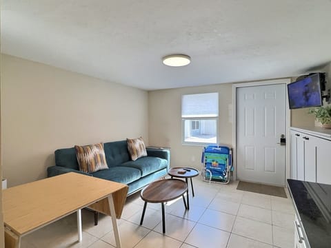 A bright living room with a comfortable sofa, armchairs, and a coffee table.