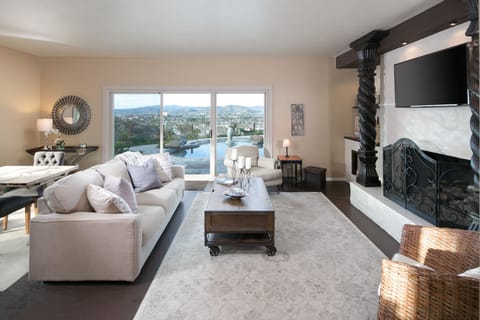 Living area overlooking heated salt water pool and city below.