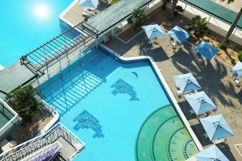 Outdoor pool, pool umbrellas, lifeguards on site