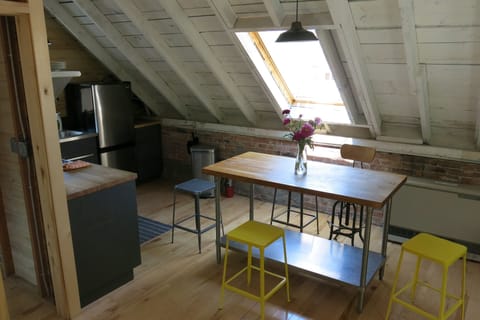 A large butcher block table serves dual purpose for dining or prepping your meal