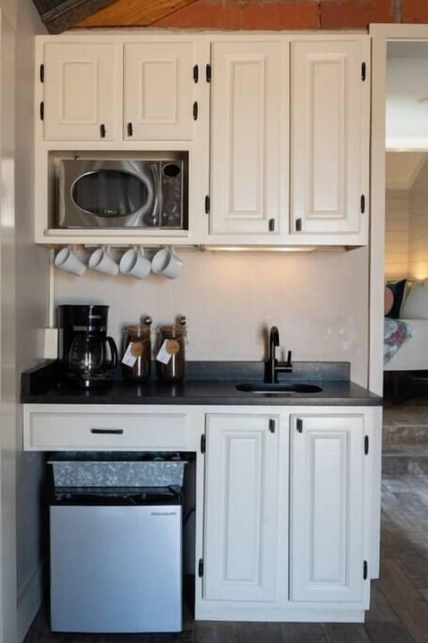 Kitchenette – Mini-fridge, microwave, and sink.