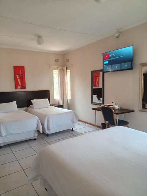 Basic Quadruple Room, Garden View | Desk, laptop workspace, iron/ironing board (on request), WiFi (free)