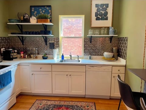 Sunny kitchen with eat in bar  opens onto the dining room stocked for your stay.