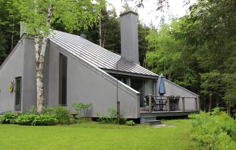 Falcon house in spring, view to deck and garden and brook