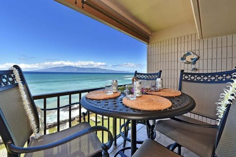 Private balcony with island views and table set for al fresco dining