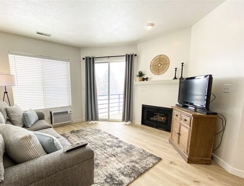 Cozy living room with fireplace and private balcony access