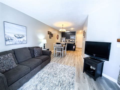 Bright living space with comfortable seating and modern kitchen nearby