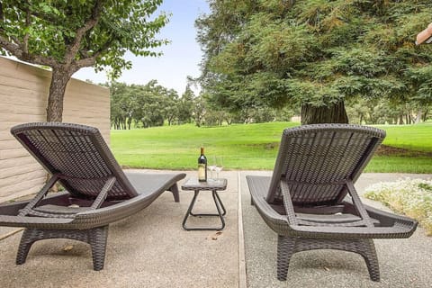 Relax on the back patio located on the fairway