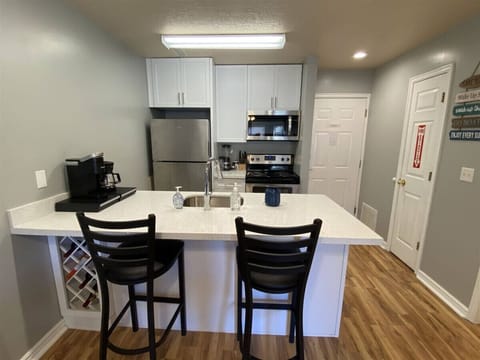 Fully equipped kitchen with seating, sleek finishes, and ample prep space