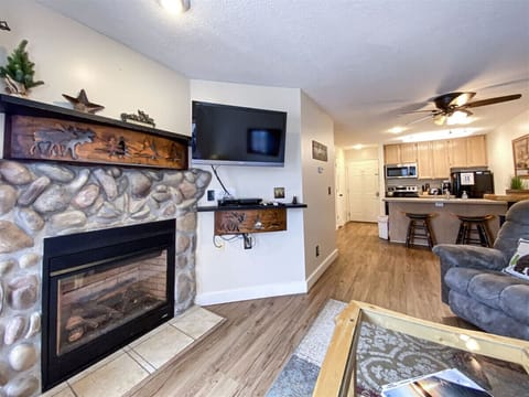 Cozy up by the rustic fireplace in this warm, welcoming retreat with modern comforts.