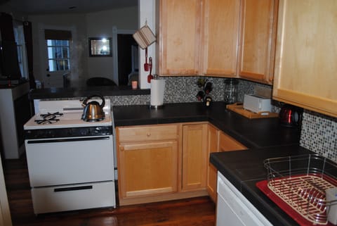 The kitchen adjoins the living room with comfortable sofa and high top table 