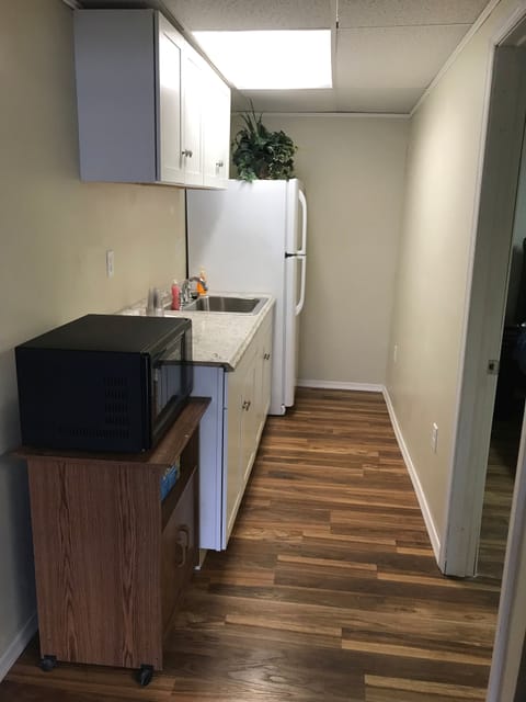 Kitchenette off the family room with another refrigerator and microwave. 