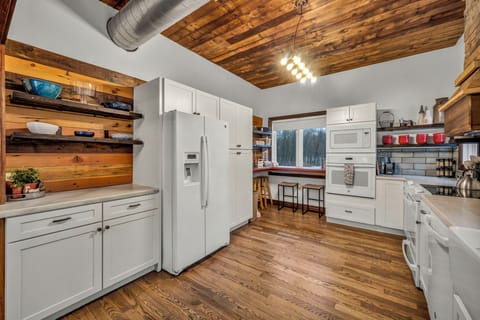 Newly renovated kitchen with modern appliances, double ovens, and open flow to the living area. Features coffee/tea bar, Instant Pot, crock pot, griddle, blender, and more, perfectly equipped for any group gathering. Just ask, we likely have it!