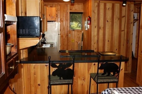 Kitchen with furnishings and plates, silverware, cups, cooking items, etc