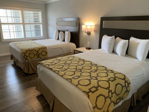 Premium bedding, desk, laptop workspace, iron/ironing board