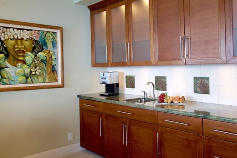 Coffee maker, mini fridge, sink, microwave and music center of the master suite