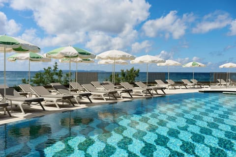 Seasonal outdoor pool, open 10:00 AM to 6:00 PM, pool umbrellas