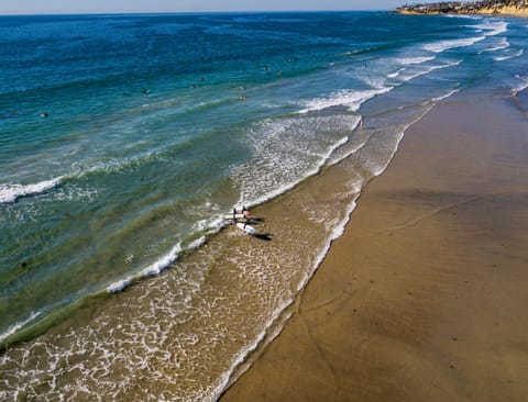 Beach nearby, white sand, beach umbrellas, beach towels