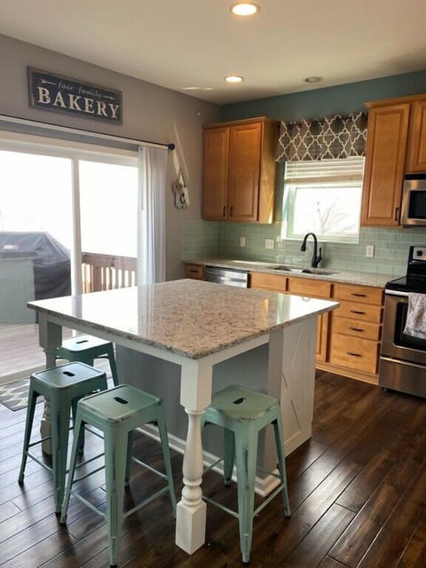 Kitchen with granite countertops and island with seating for four