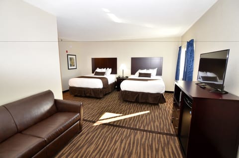 Deluxe Suite | Premium bedding, desk, laptop workspace, blackout drapes