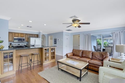 Open concept kitchen and family area featuring a breakfast bar