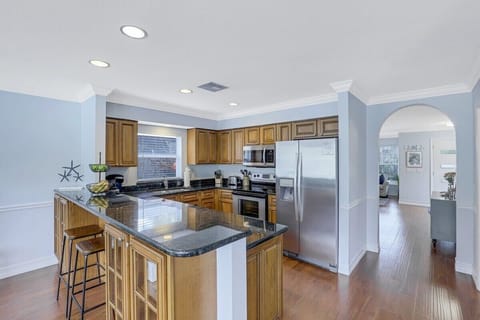 Stainless appliances and easy access to dining area just thru arch