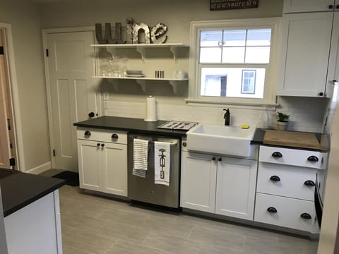 New cabinets, dishwasher and farm sink.