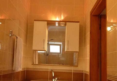 Shower, hair dryer, slippers, towels