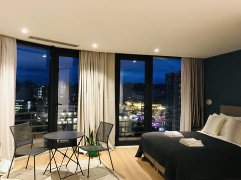 Panoramic Room, City View | Living area | Flat-screen TV