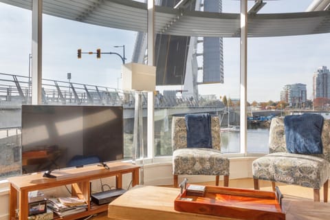Welcome to your long-term sanctuary! Relax in a curved living area surrounded by floor-to-ceiling views of the active waterway.