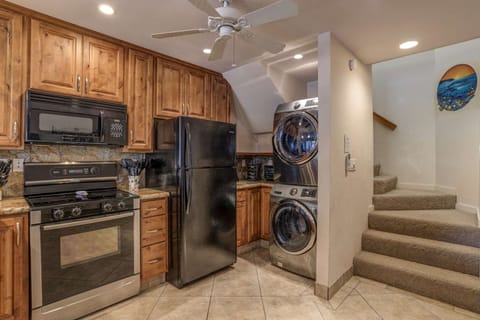 Another view of the Kitchen w/ Stackable W/D and stairs to bedrooms
