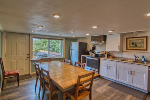 The dining area showcases a wooden table with seating for six.