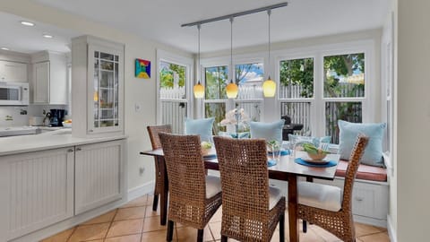 Gather around this bright dining nook where your meals become memories, bathed in natural light from expansive windows.