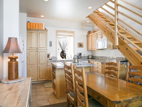 Interior Dining Area with Kitchen and Stairs - Interior dining area with kitchen in background and stairs to loft.