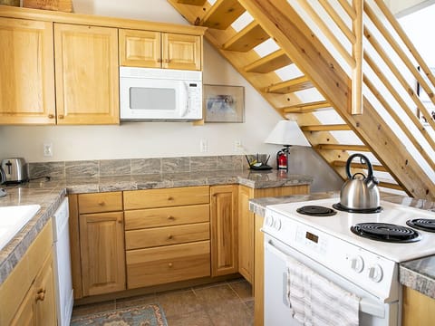 Interior Kitchen with Stove and Microwave - Interior kitchen with stove and microwave located under stairs to loft.