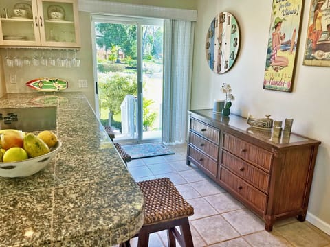 Sliding door leads to backyard barbecue lanai