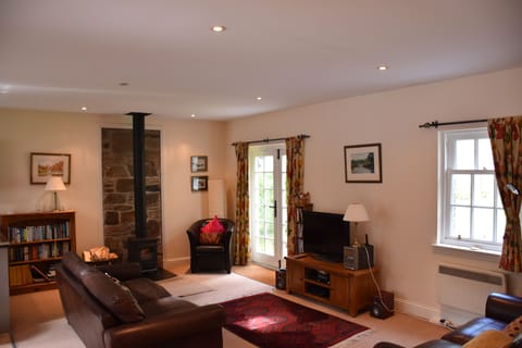Open plan living area with wood burner