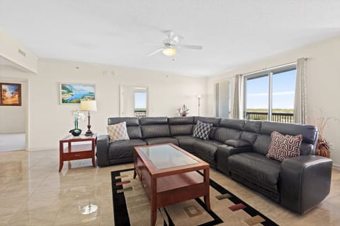 Living Room with Reclining Sectional and Balcony Access