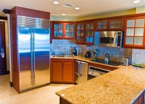 Chef's kitchen with granite counters, premium appliances & bar seating