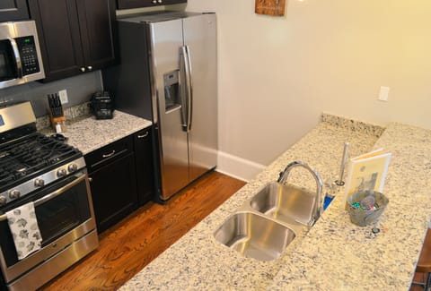 Galley style kitchen with stainless appliances and gas stove