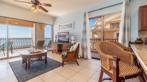 Living room with lots of windows, seating at the kitchen counter as well