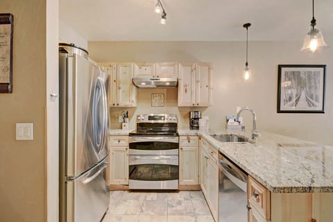 The kitchen features granite counter-tops and stainless steel appliances. 