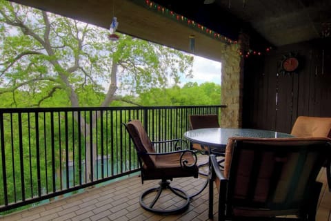 The covered balcony offers views of the river, great for sipping coffee in the morning or watching tubers float by during an outdoor dinner. 