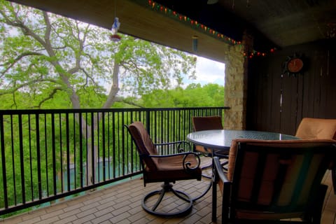 The covered balcony offers views of the river, great for sipping coffee in the morning or watching tubers float by during an outdoor dinner.