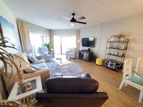 Bright, inviting living room with plush seating and large windows.