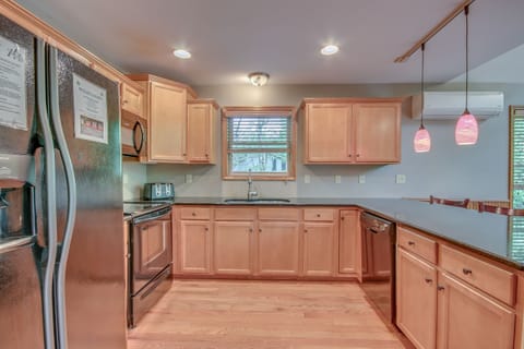 Kitchen interior featuring an island, sink and refrigerator