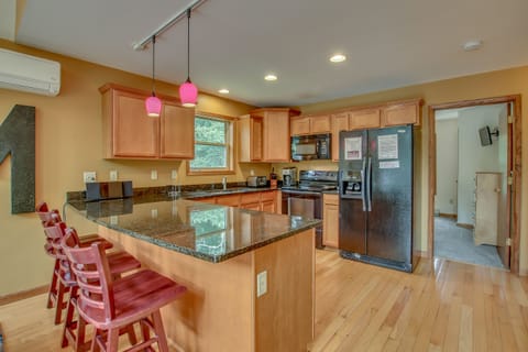 kitchen view with several chairs and a refrigerator