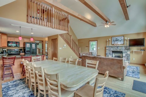 dining room table and couches beneath stairwell